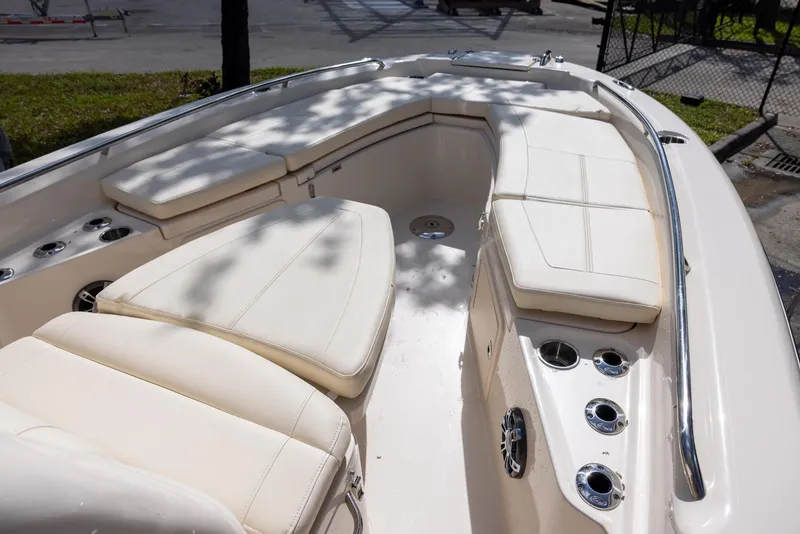 Slide: The Image of 2021 Grady-White 251 Coastal Explorer boat interior with cushioned seating and cup holders. - 9
