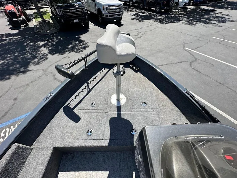 Slide: The Image of 2020 Tracker Pro Guide V-16 SC boat with elevated seat in a parking lot. - 13