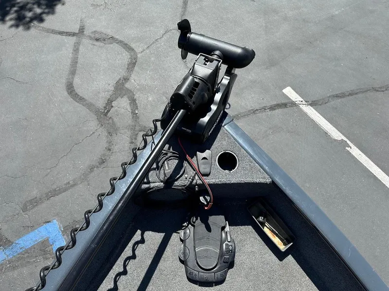 Slide: The Image of 2020 Tracker Pro Guide V-16 SC boat with trolling motor on asphalt surface. - 16