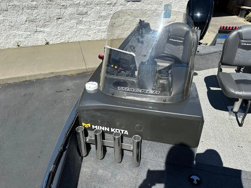 Slide: The Image of 2020 Tracker Pro Guide V-16 SC boat with Minn Kota accessories, parked outdoors. - 18