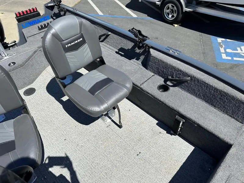 Slide: The Image of 2020 Tracker Pro Guide V-16 SC boat interior with gray seating and fishing rod holders. - 19