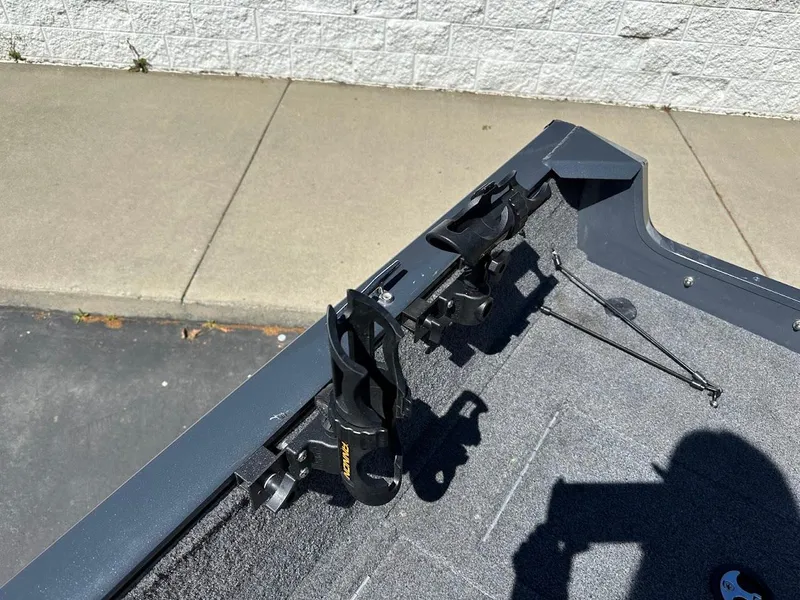 Slide: The Image of 2020 Tracker Pro Guide V-16 SC boat interior with rod holders, gray carpet, and shadow. - 21