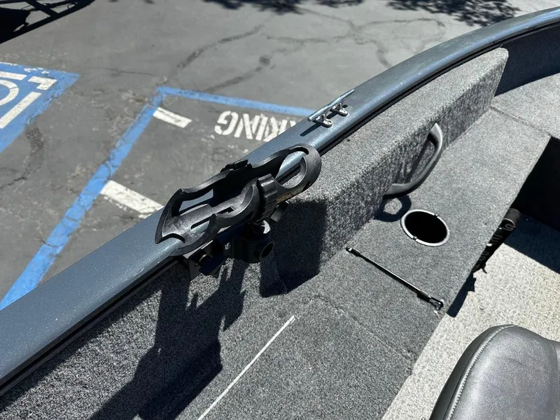 Slide: The Image of 2020 Tracker Pro Guide V-16 SC boat interior with rod holder and carpeted deck. - 23