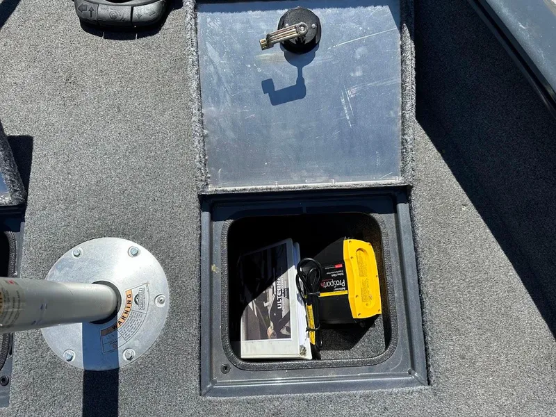Slide: The Image of Storage compartment in 2020 Tracker Pro Guide V-16 SC boat with manuals and equipment. - 31