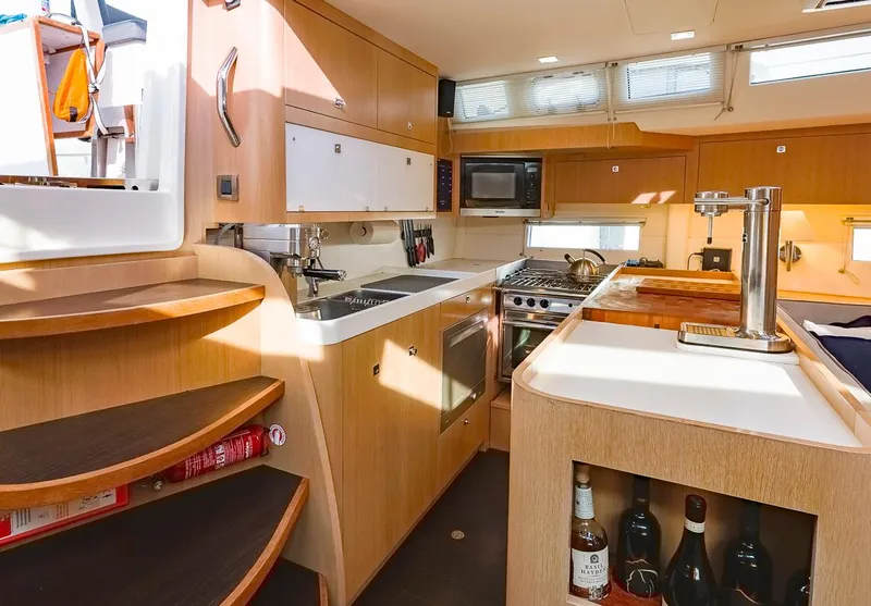 Slide: The Image of Modern kitchen interior of 2018 Amel 55 yacht with wooden cabinetry and appliances. - 15