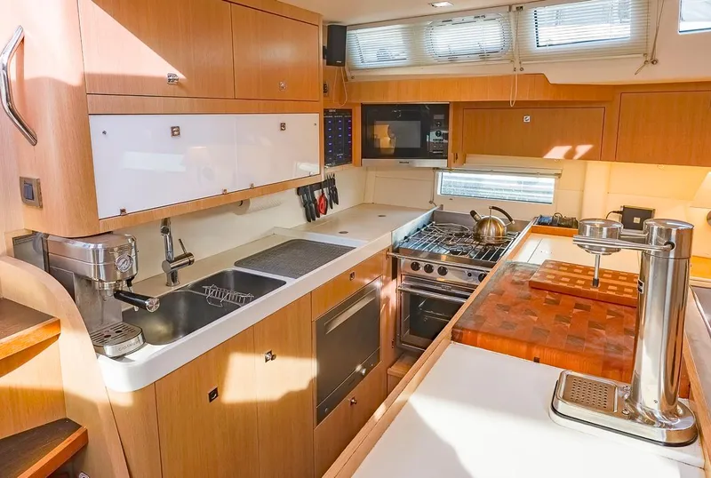 Slide: The Image of Modern kitchen interior of 2018 Amel 55 yacht with wooden cabinetry and stainless steel appliances. - 16