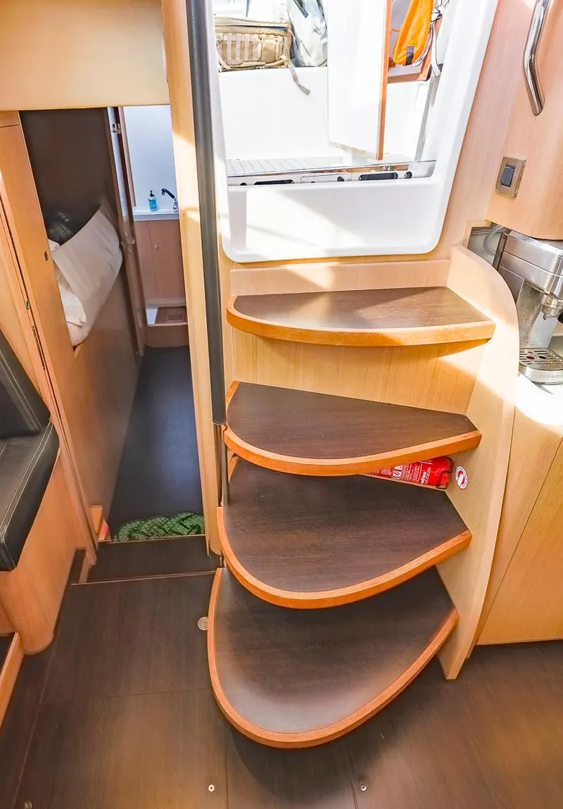 Slide: The Image of Interior of 2018 Amel 55 yacht featuring curved wooden steps and modern design. - 18