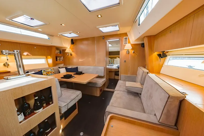 Slide: The Image of Luxurious interior of a 2018 Amel 55 yacht with modern seating and dining area. - 2