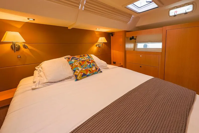 Slide: The Image of Luxurious cabin interior of 2018 Amel 55 yacht with cozy bed and warm lighting. - 24