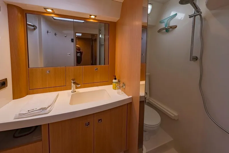 Slide: The Image of Luxurious bathroom in 2018 Amel 55 yacht with modern fixtures and wooden cabinetry. - 25