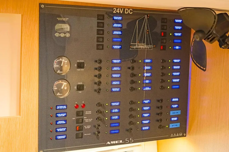 Slide: The Image of Electrical control panel of a 2018 Amel 55 yacht, featuring 24V DC switches and gauges. - 28