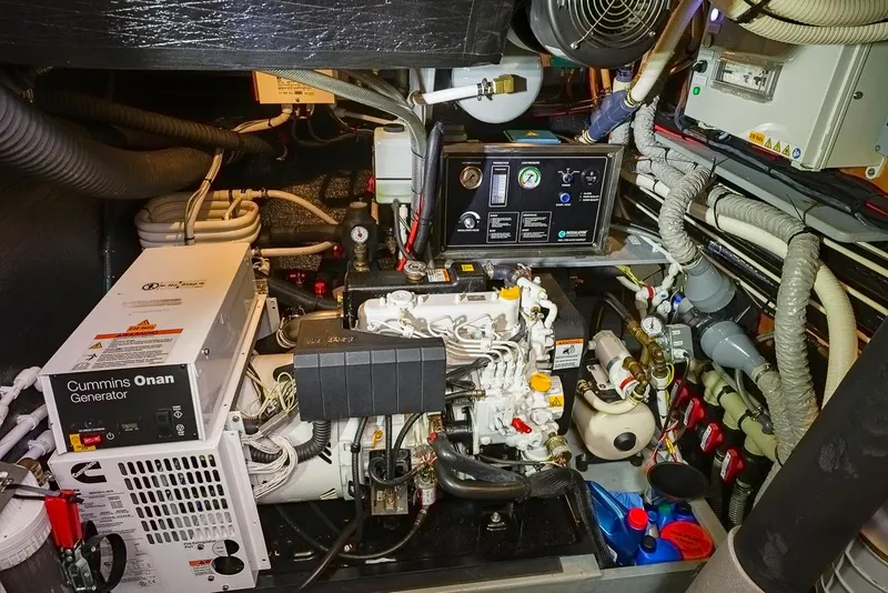 Slide: The Image of Engine room of a 2018 Amel 55 yacht featuring a Cummins Onan generator. - 29