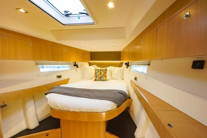 Slide: The Image of Luxurious cabin interior of 2018 Amel 55 yacht with cozy bed and wooden finish. - 3