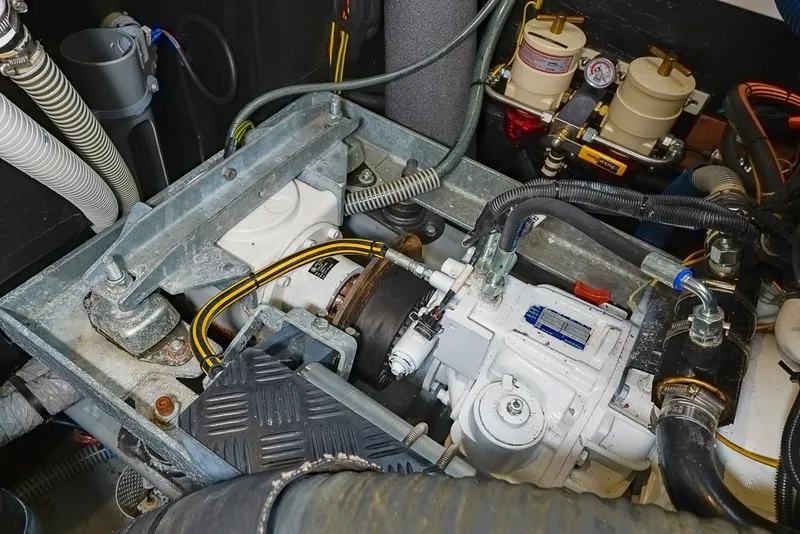 Slide: The Image of Engine compartment of a 2018 Amel 55 yacht, showcasing mechanical components and wiring. - 32