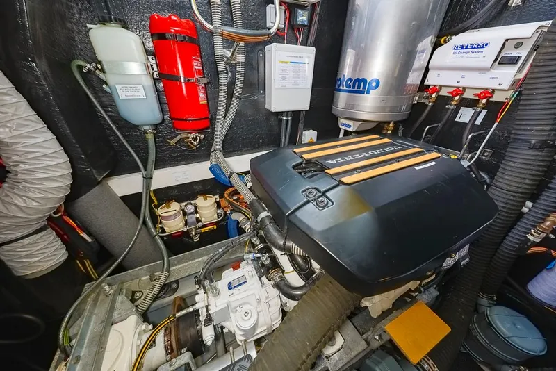 Slide: The Image of Engine room of a 2018 Amel 55 yacht, featuring mechanical components and safety equipment. - 34