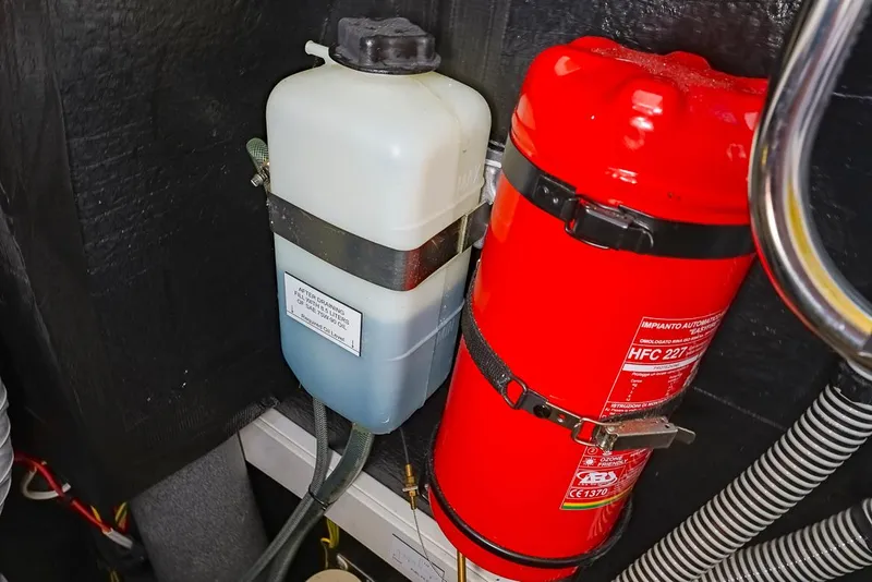 Slide: The Image of Coolant tank and fire extinguisher in 2018 Amel 55 engine compartment. - 37