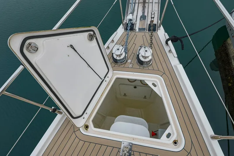 Slide: The Image of Open hatch on 2018 Amel 55 yacht deck, revealing interior storage space. - 41