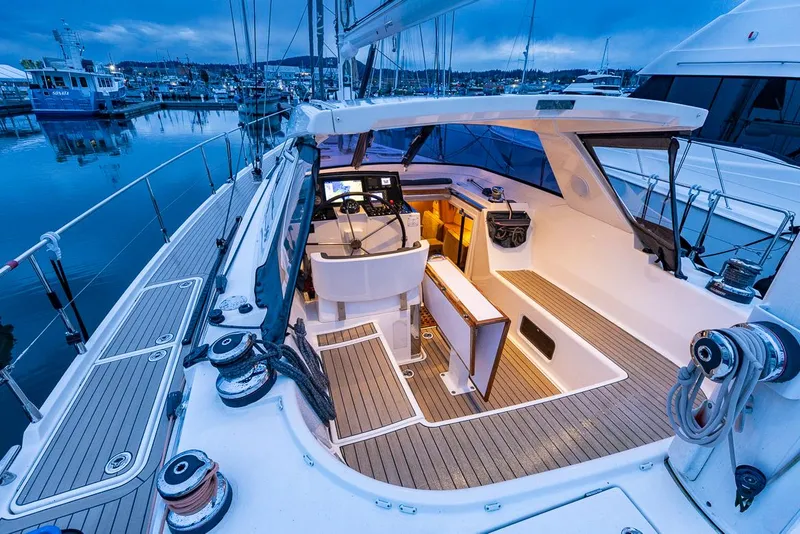 Slide: The Image of Luxurious 2018 Amel 55 yacht cockpit with modern navigation equipment, docked at a serene marina. - 46