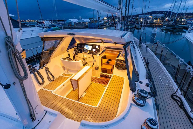 Slide: The Image of Luxurious 2018 Amel 55 yacht cockpit with illuminated interior at marina. - 48