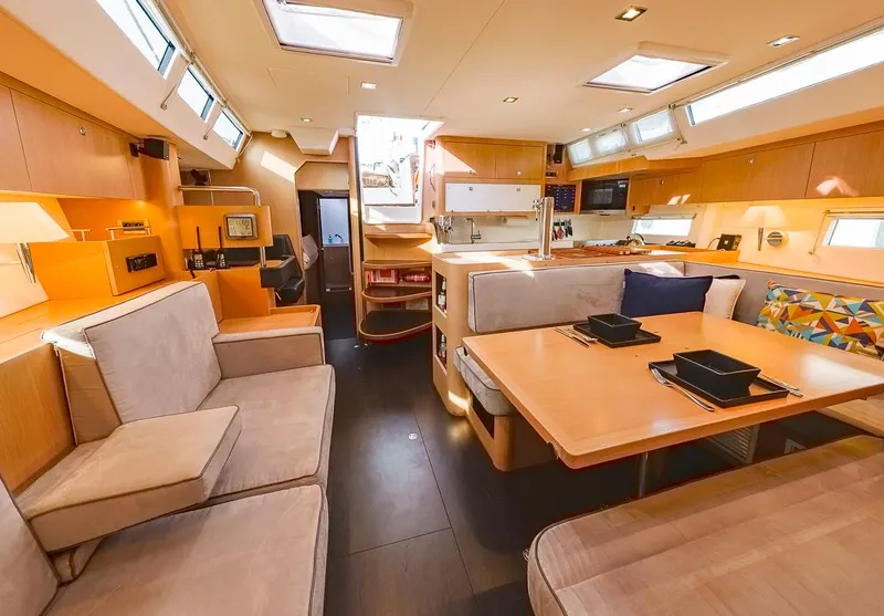 Slide: The Image of Luxurious interior of a 2018 Amel 55 yacht, featuring modern seating and dining area. - 8