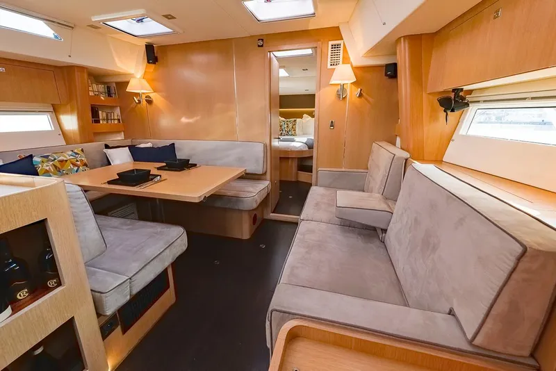 Slide: The Image of Luxurious interior of 2018 Amel 55 yacht with cozy seating and elegant wooden finishes. - 9