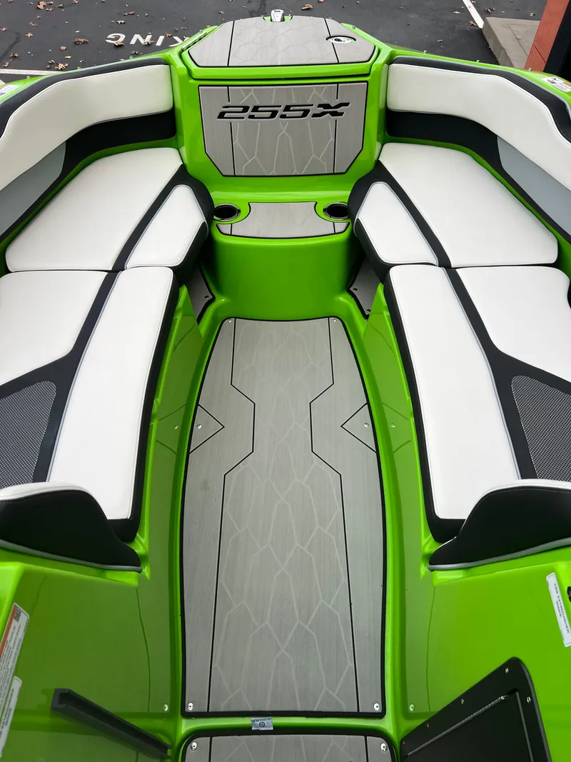 Slide: The Image of 2022 Yamaha Boats 255XD interior with green and white seating, showcasing modern design. - 7