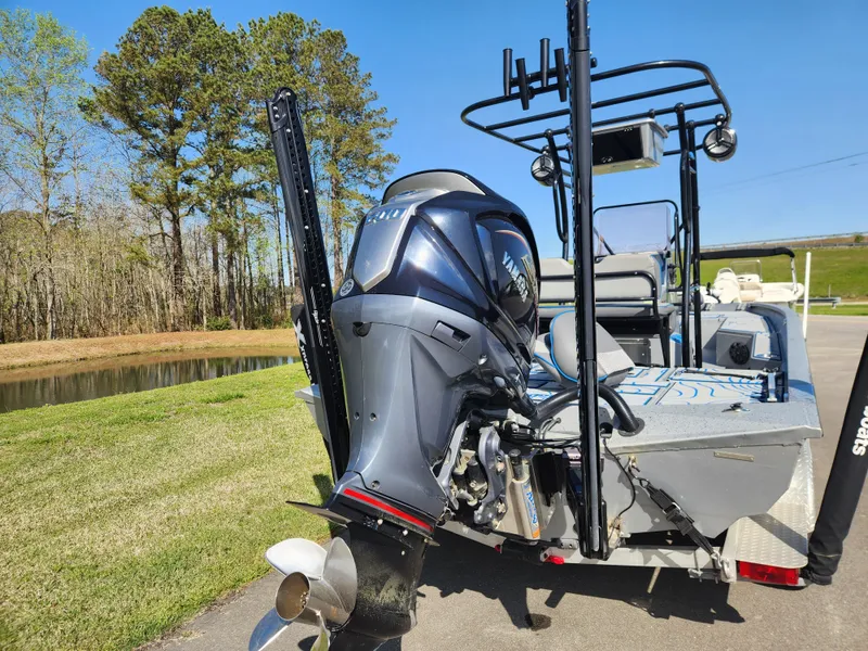 Slide: The Image of 2022 Xpress H22B boat with Yamaha outboard motor, parked near a scenic waterway. - 3