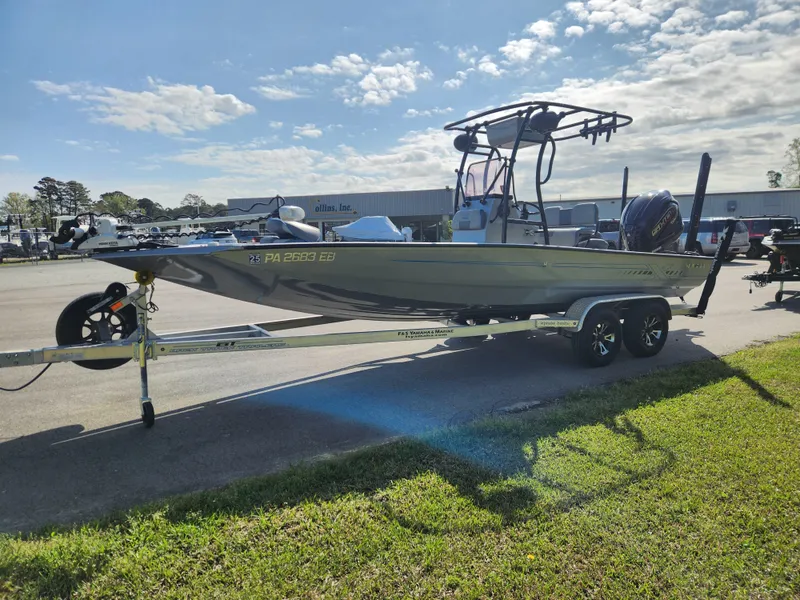 Slide: The Image of 2022 Xpress H22B boat on trailer, parked outdoors under a partly cloudy sky. - 6