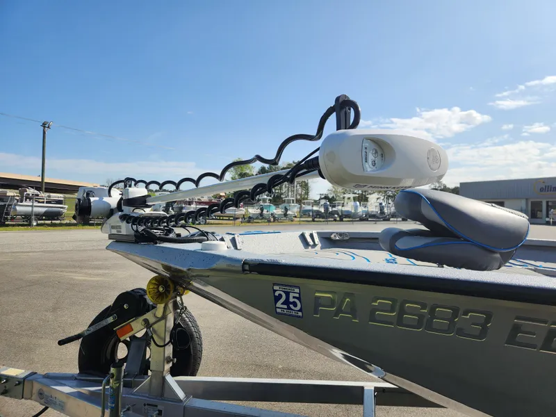 Slide: The Image of 2022 Xpress H22B boat on trailer, featuring a mounted trolling motor under a clear blue sky. - 7