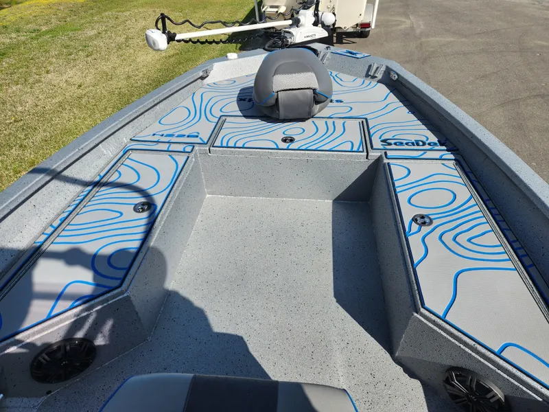 Slide: The Image of 2022 Xpress H22B boat interior with blue patterned deck and seating. - 8