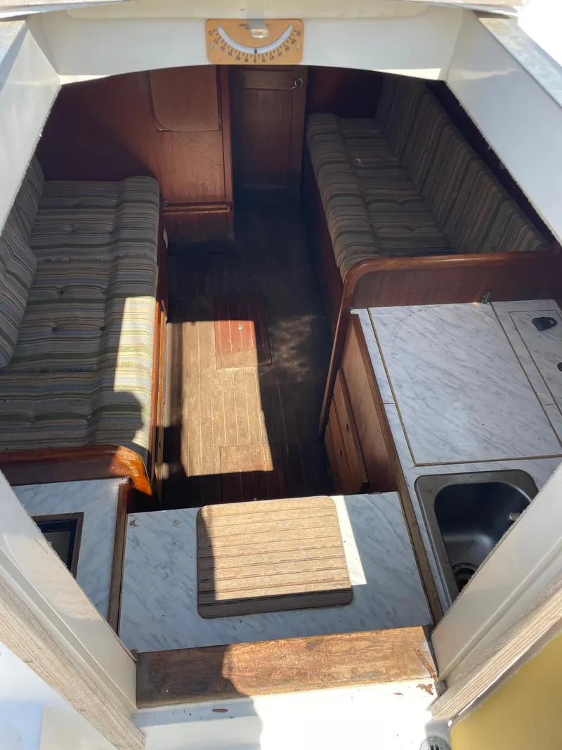 Slide: The Image of Interior of a 1979 Bristol 32 sailboat with seating and kitchenette. - 18