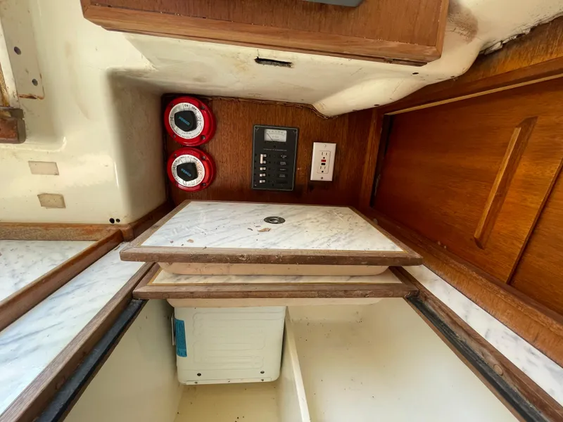 Slide: The Image of 1979 Bristol 32 yacht interior with wooden cabinetry and control panel. - 24