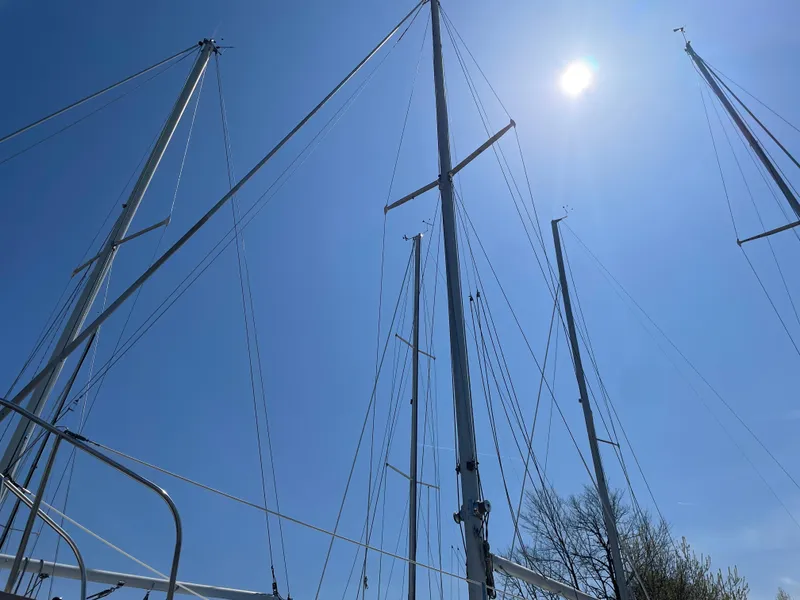 Slide: The Image of Masts of a 1979 Bristol 32 sailboat against a clear blue sky. - 4