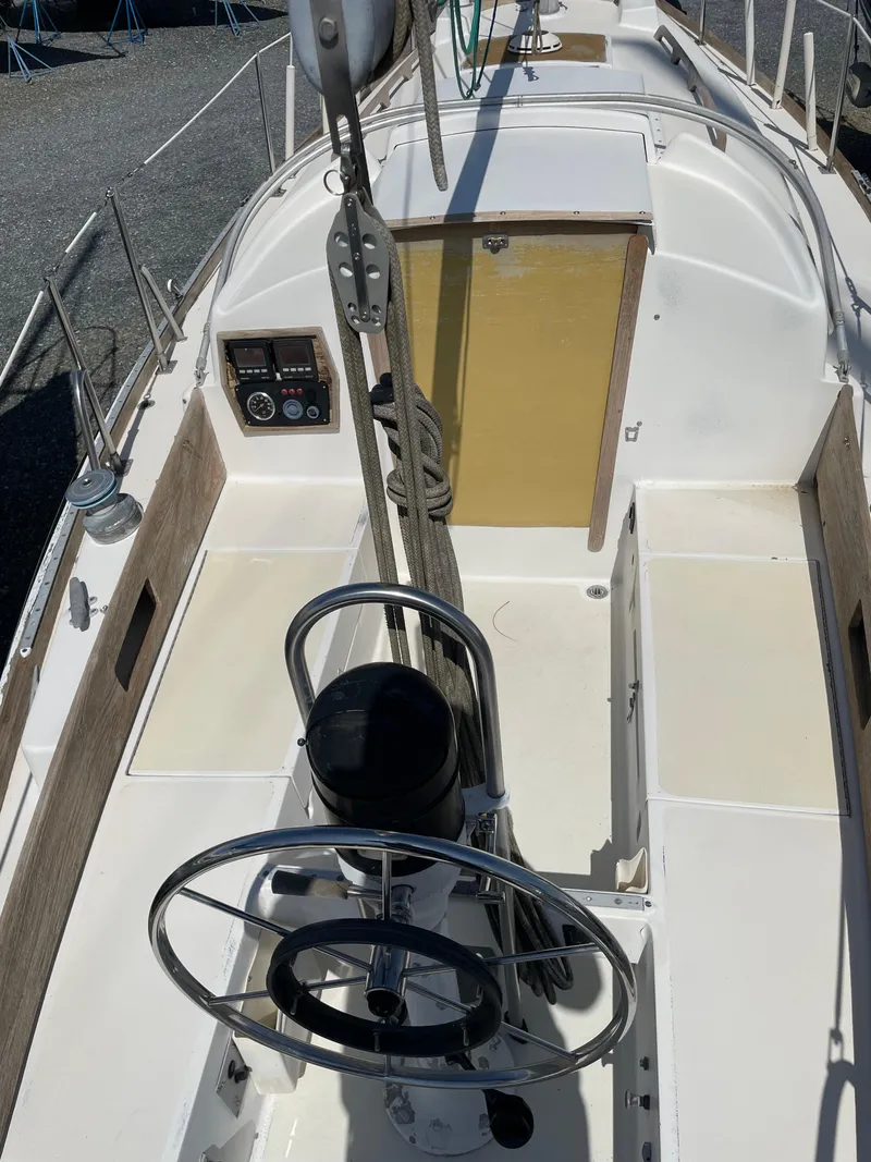 Slide: The Image of 1979 Bristol 32 sailboat cockpit with steering wheel and control panel. - 6