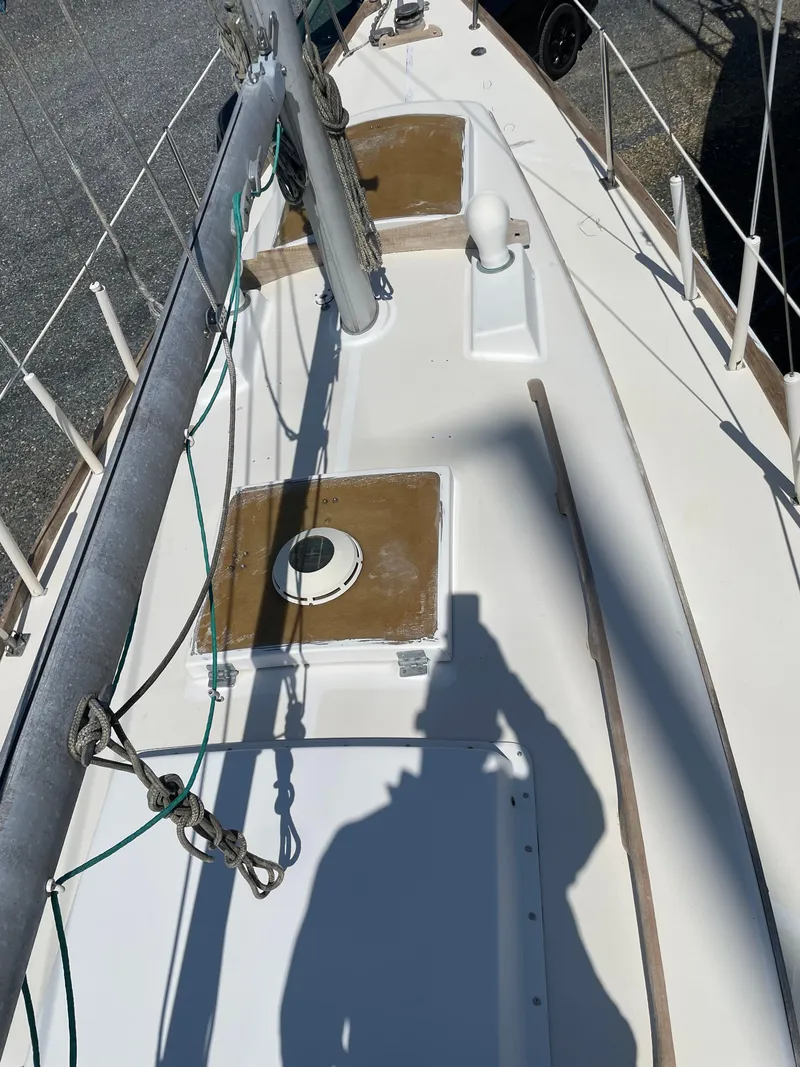 Slide: The Image of 1979 Bristol 32 sailboat deck with mast and rigging, shadow visible. - 8