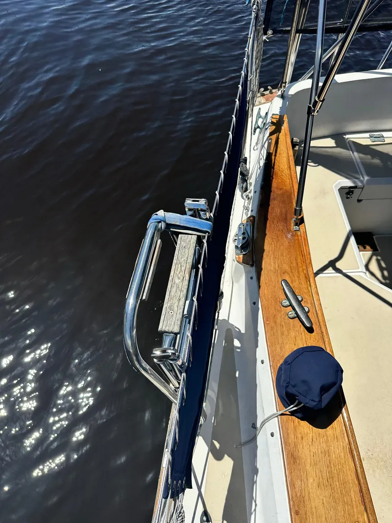 Slide: The Image of 1988 Cape Dory 30 MK II sailboat deck with wooden trim and water view. - 16