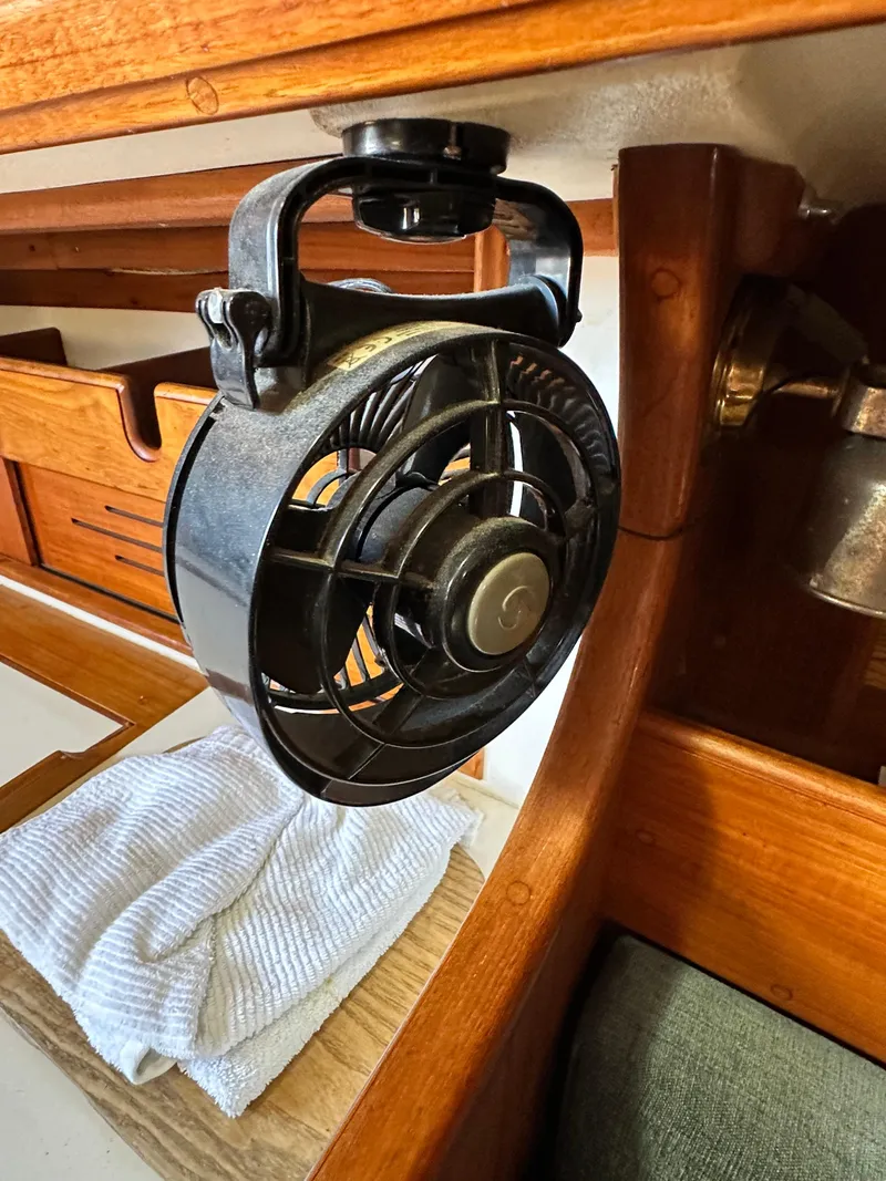 Slide: The Image of 1988 Cape Dory 30 MK II interior with mounted fan and wooden cabinetry. - 30