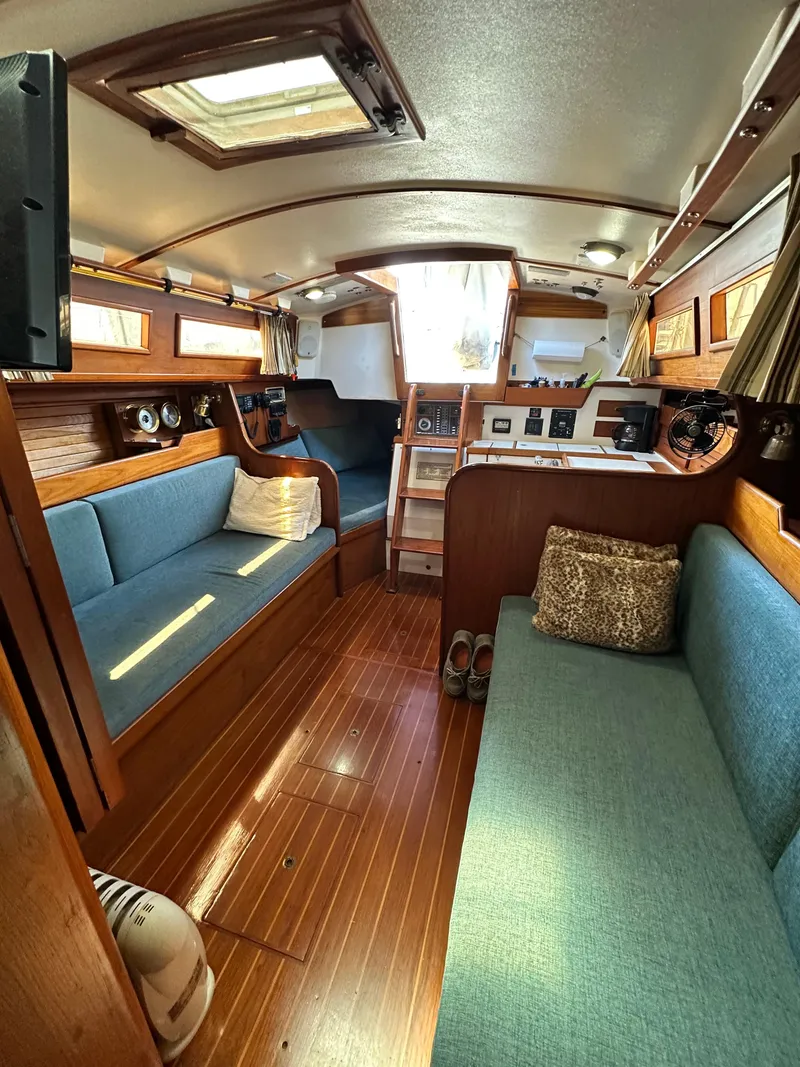 Slide: The Image of Interior of a 1988 Cape Dory 30 MK II sailboat with blue seating and wood finish. - 35