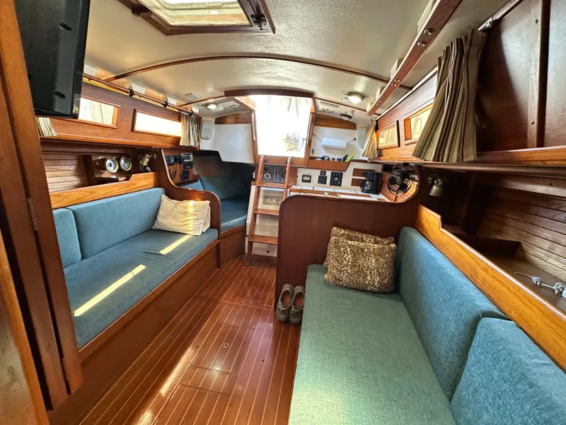 Slide: The Image of Interior of 1988 Cape Dory 30 MK II sailboat with wooden finish and blue seating. - 37