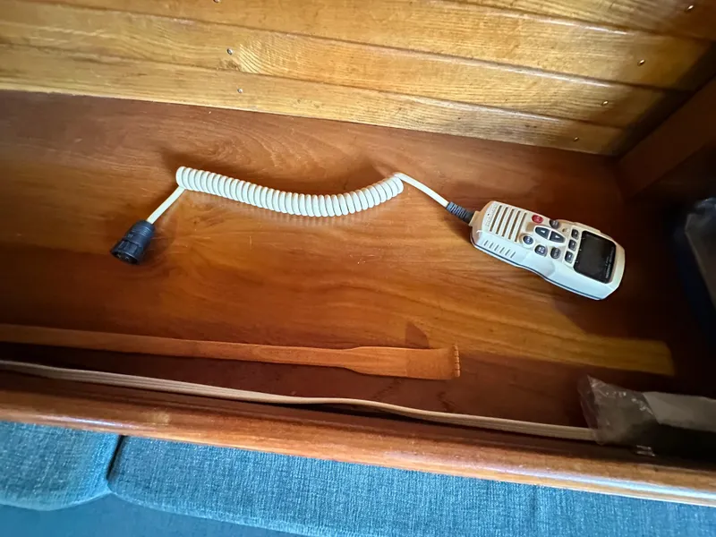 Slide: The Image of VHF radio handset on wooden shelf in 1988 Cape Dory 30 MK II sailboat interior. - 41