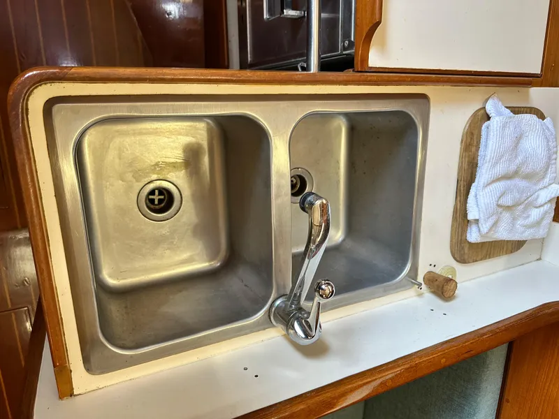 Slide: The Image of Double sink in 1988 Cape Dory 30 MK II yacht galley with wooden trim. - 47