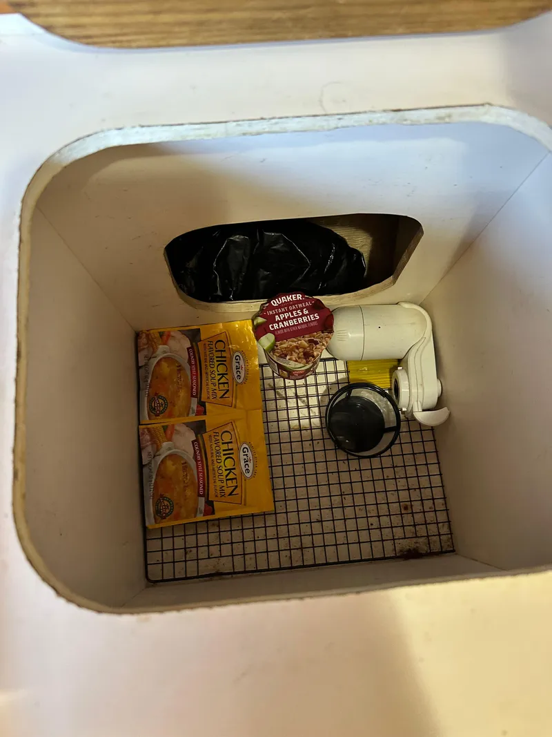 Slide: The Image of Storage compartment in 1988 Cape Dory 30 MK II with soup packets and equipment. - 48