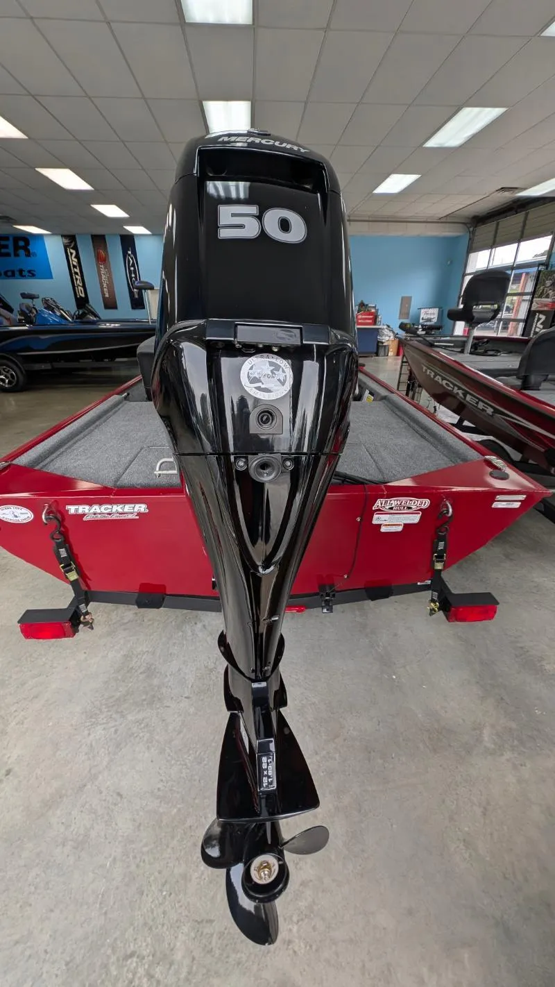 Slide: The Image of 2025 Bass Tracker Classic XL with 50 HP engine in showroom. - 2