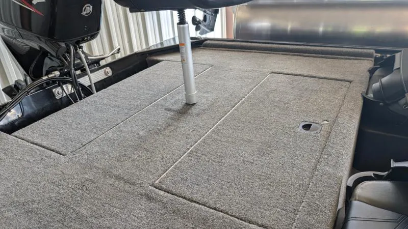 Slide: The Image of 2025 Bass Tracker Classic XL boat deck with carpeted surface and storage compartments. - 5