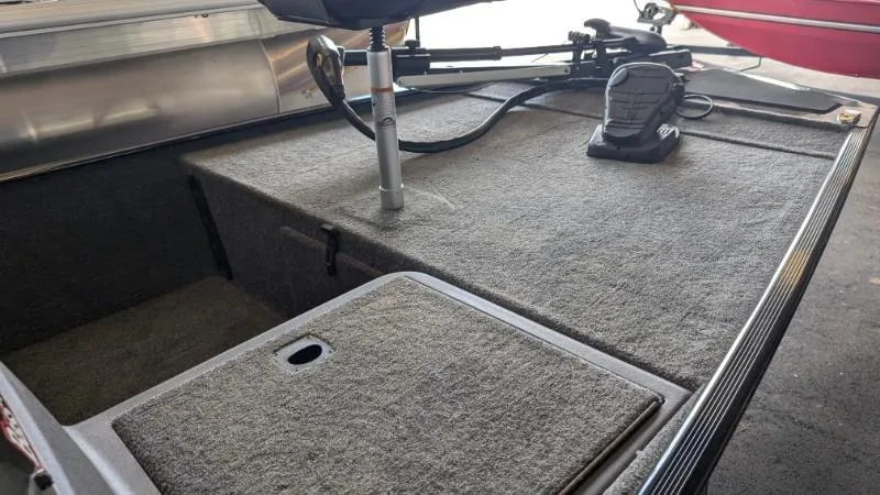 Slide: The Image of 2025 Bass Tracker Classic XL boat deck with carpeted surface and mounted equipment. - 6