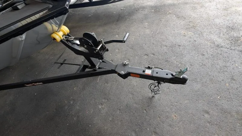 Slide: The Image of Trailer hitch of a 2025 Bass Tracker Classic XL boat on pavement. - 7