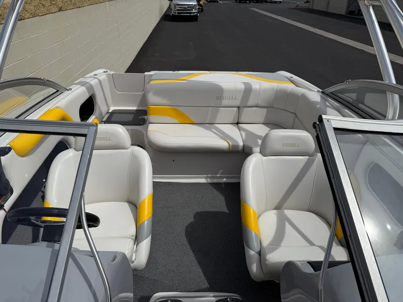 Slide: The Image of 2008 Reinell Bowrider 220LSE interior with white and yellow seating, open layout. - 12