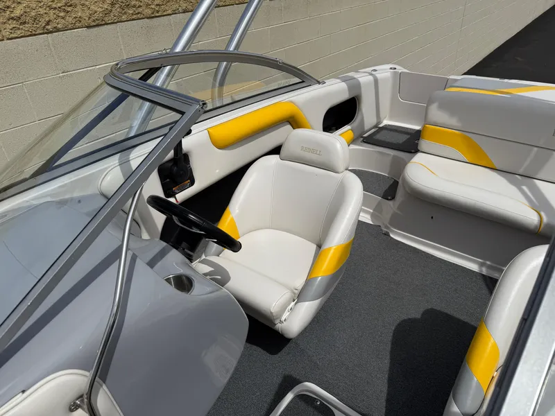 Slide: The Image of 2008 Reinell Bowrider 220LSE interior with yellow and white seating, steering wheel, and windshield. - 13