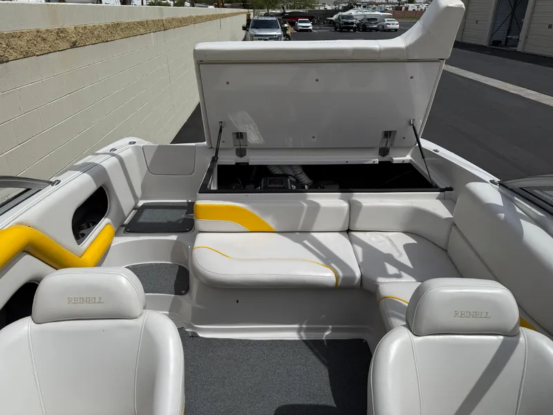 Slide: The Image of 2008 Reinell Bowrider 220LSE interior with open engine compartment, white and yellow seating. - 15