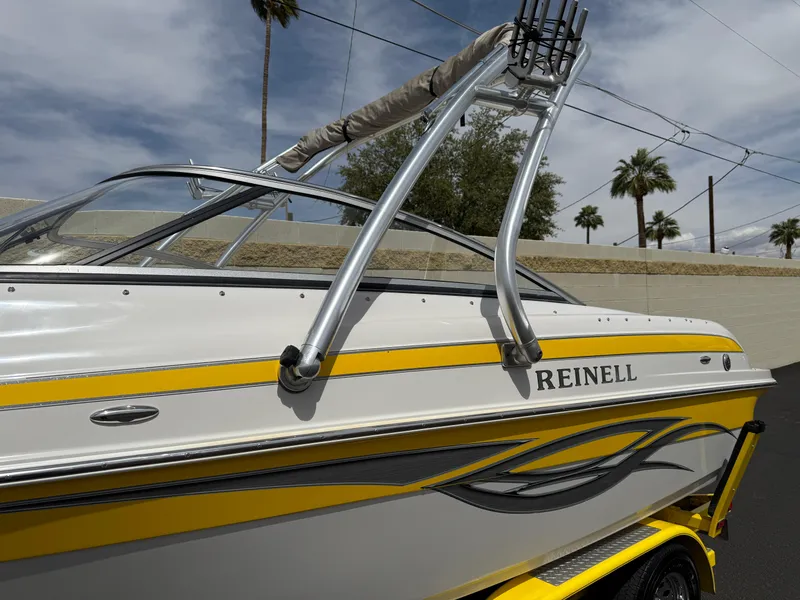 Slide: The Image of 2008 Reinell Bowrider 220LSE boat with yellow accents and sleek design. - 2